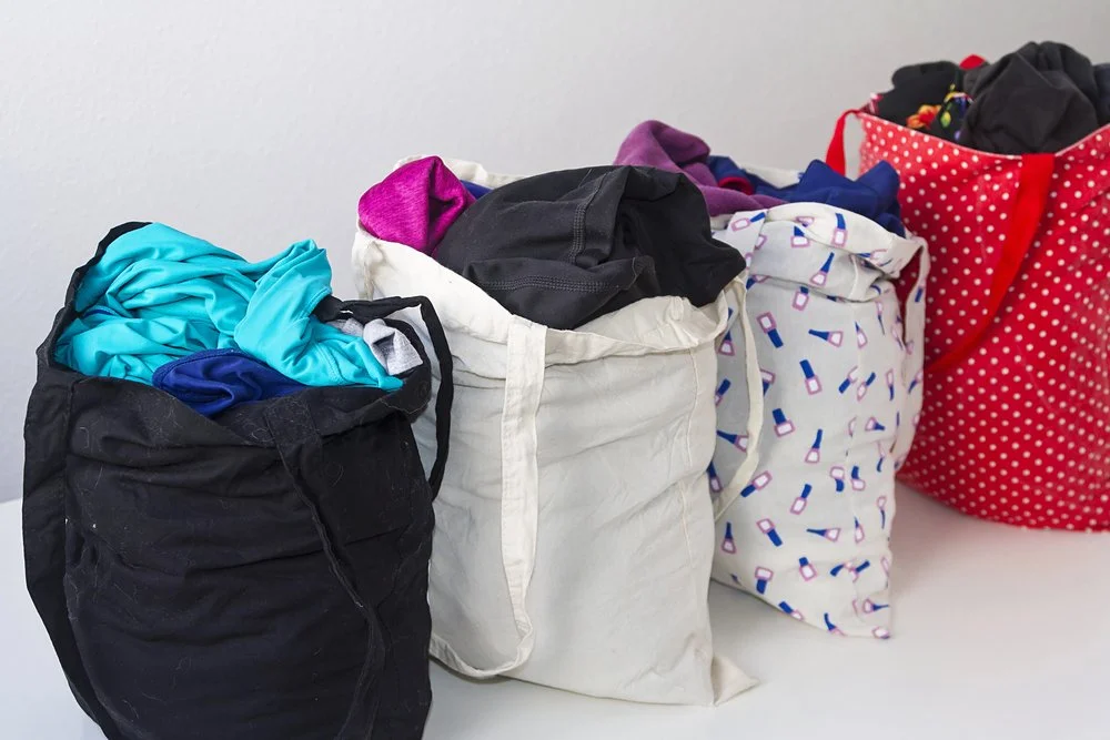 Reusable bags overflowing with clothes
